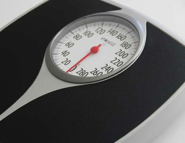 A close view of an analog bathroom scale.