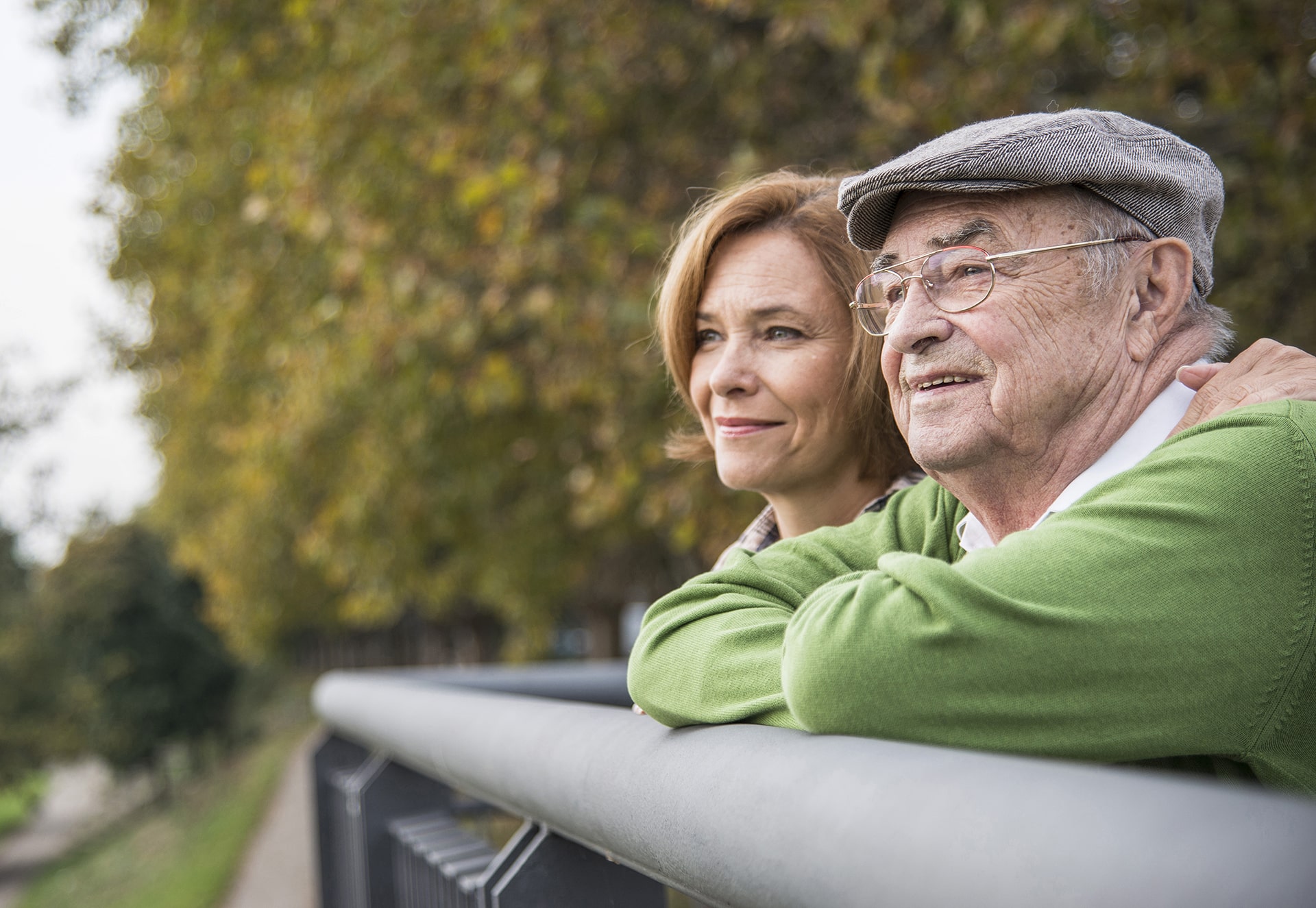 An older adult enjoys a shared activity outdoors with a caregiver.