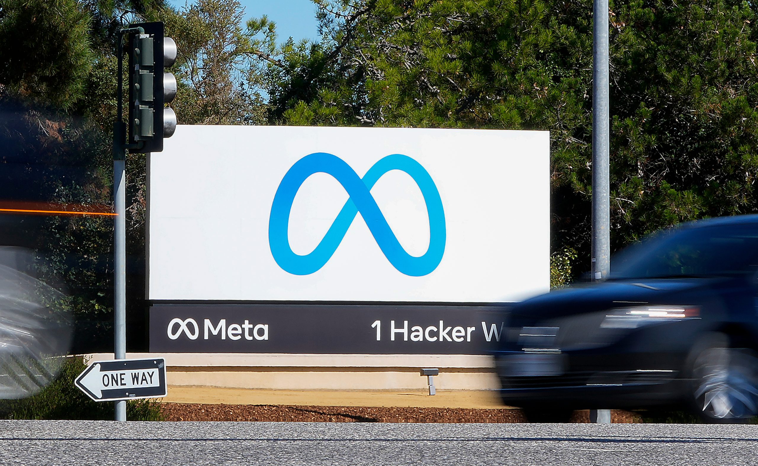 Meta logo displayed on a smartphone against a dark blue background.